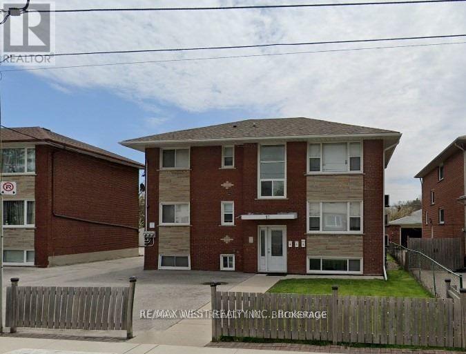 A building with a sign that says RE/MAX West Realty Inc. on the front.