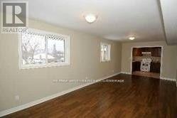 A room with wood floors and white walls.