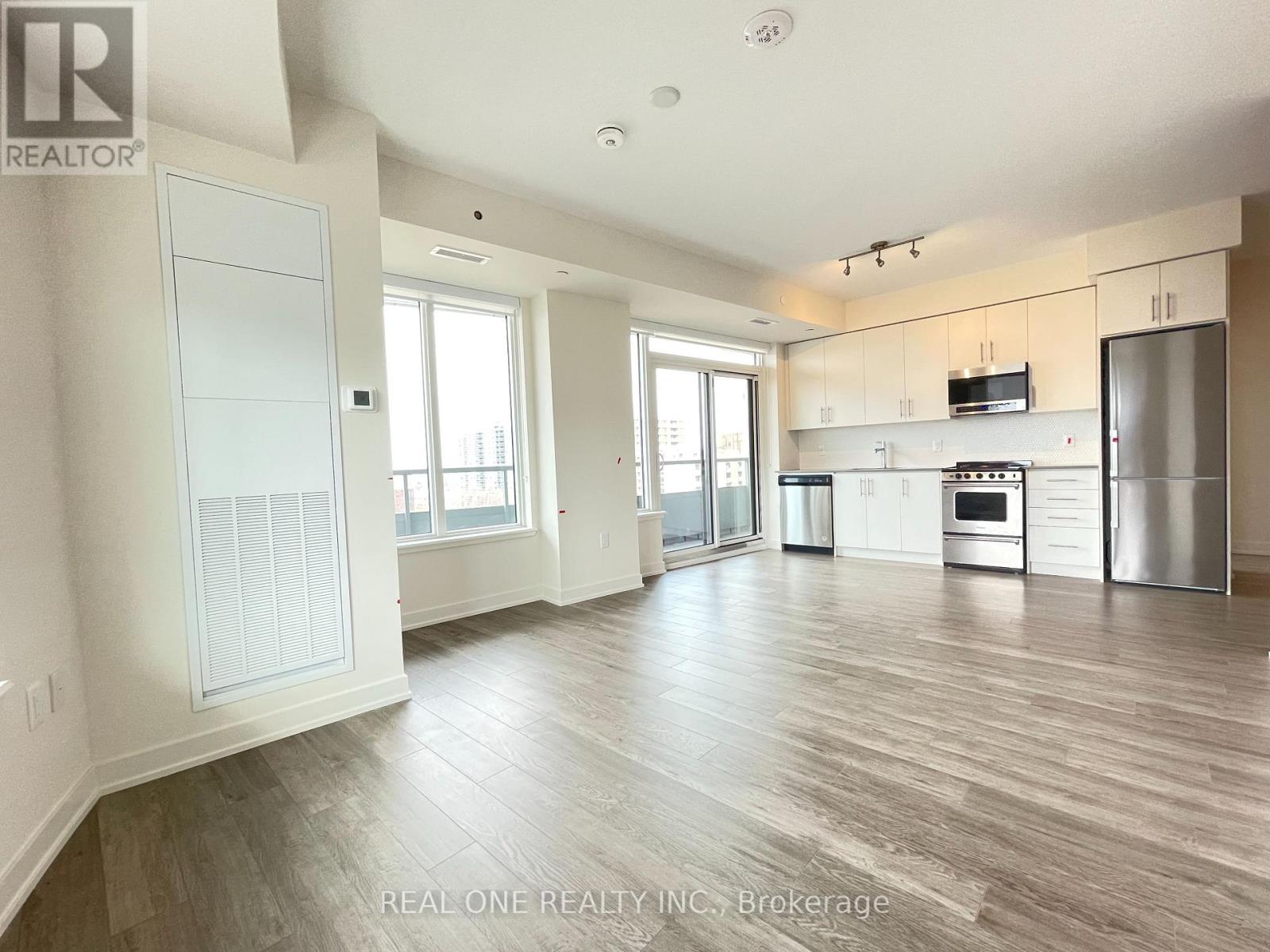 A spacious kitchen with stainless steel appliances and a dining area with a table and chairs.