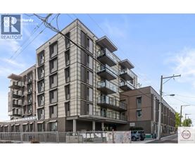 A multi-story residential building under construction with a clear sky in the background.