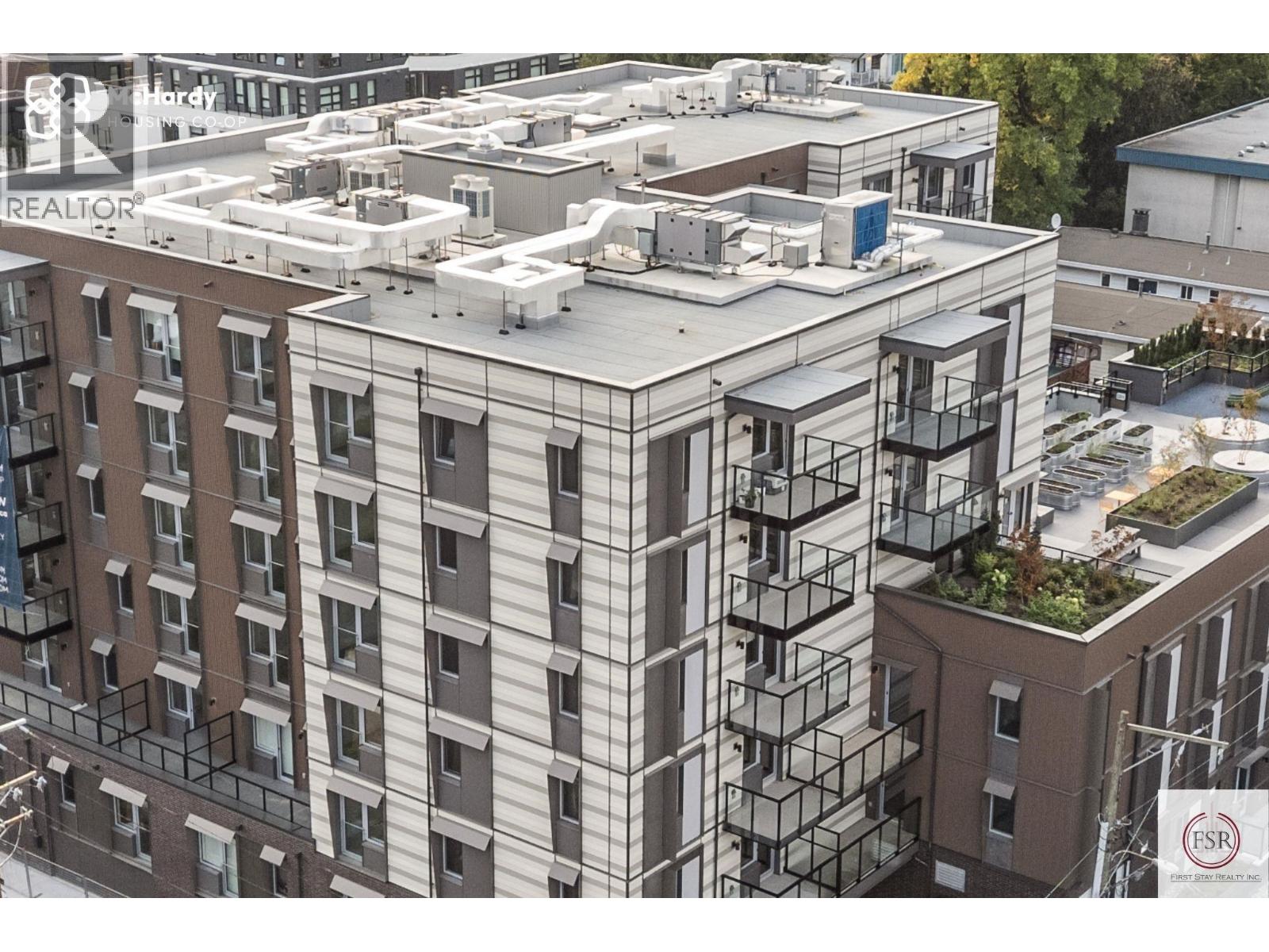 A modern apartment building with a flat roof and balconies.