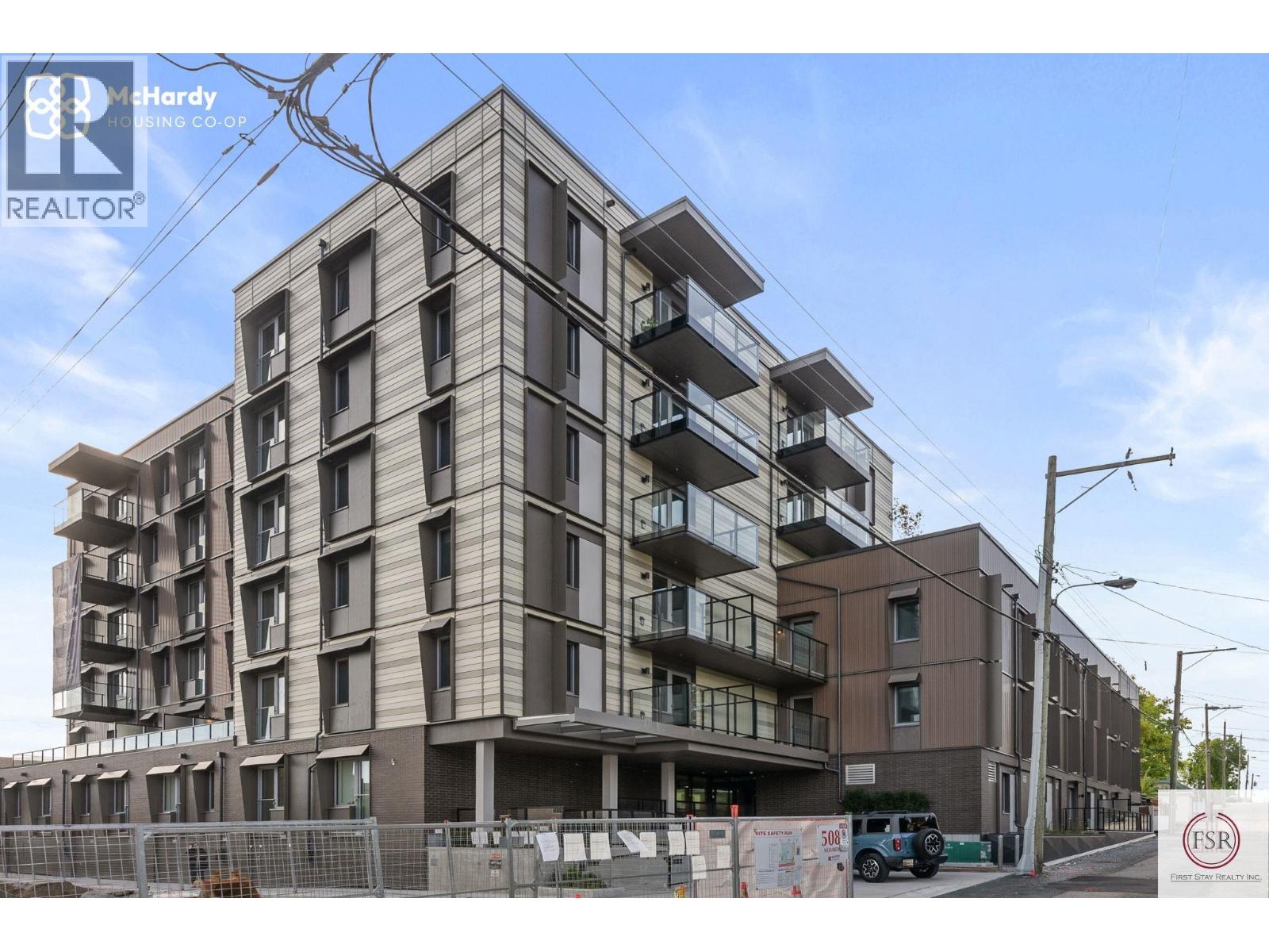 A multi-story residential building under construction with a clear sky in the background.