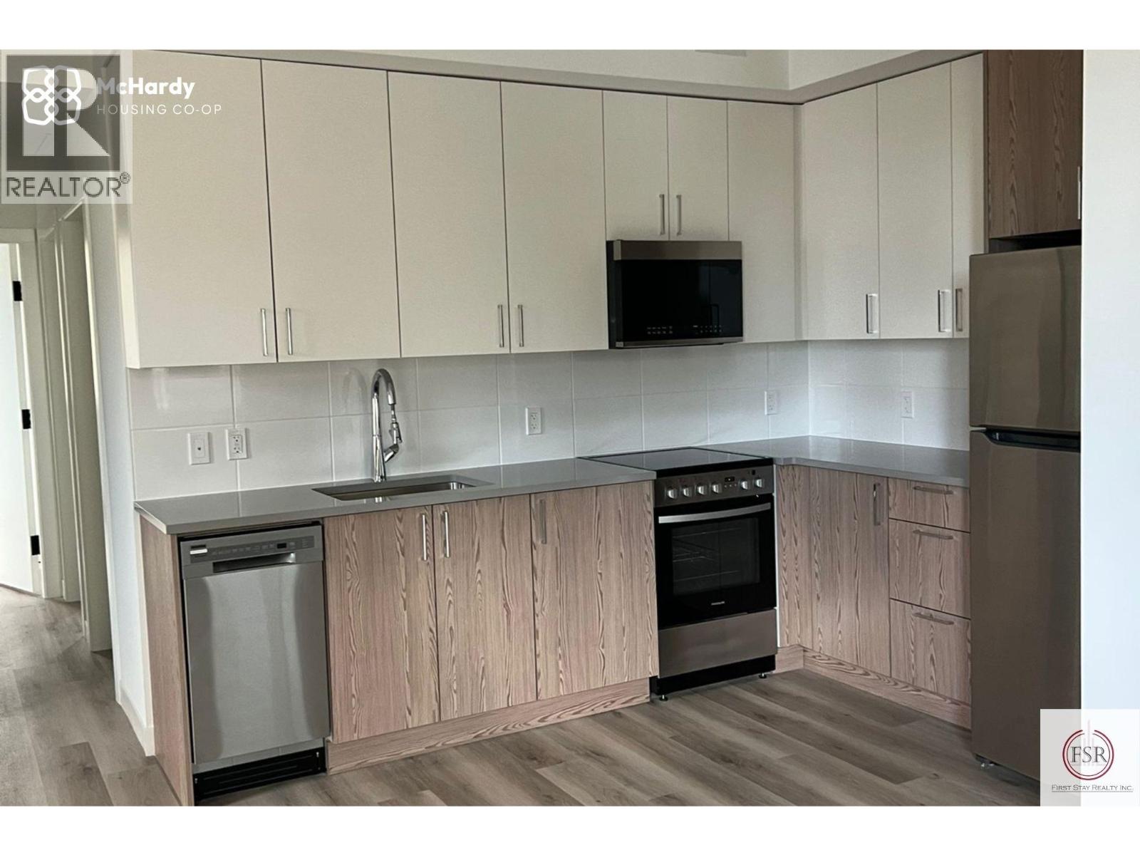 A kitchen with wooden cabinets and stainless steel appliances.