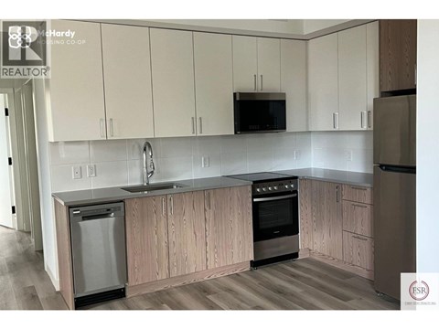 A kitchen with wooden cabinets and stainless steel appliances.
