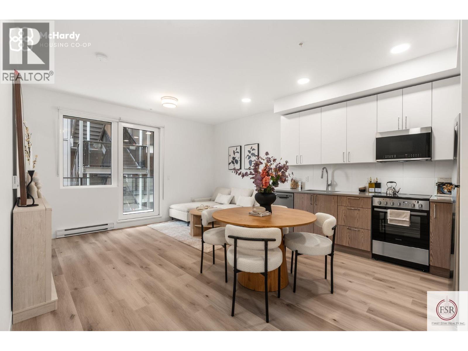 A modern kitchen with a dining table set in the middle.