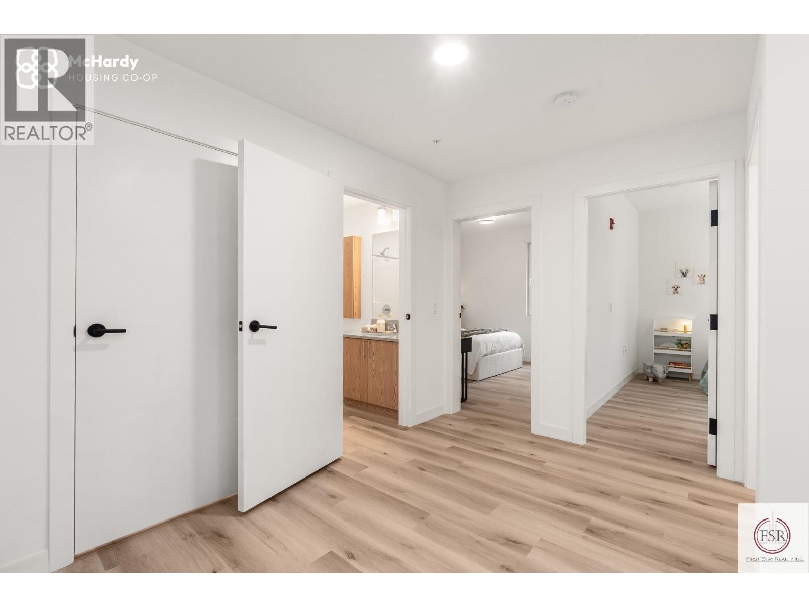 A bedroom with a bed, dresser, and wardrobe is shown in this image.
