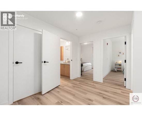 A bedroom with a bed, dresser, and wardrobe is shown in this image.