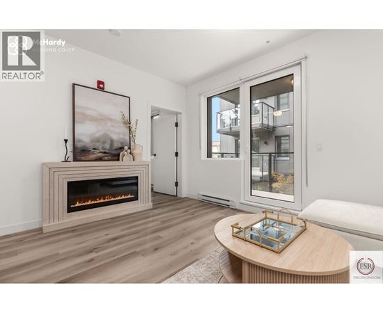 A modern living room with a fireplace and a painting on the wall.