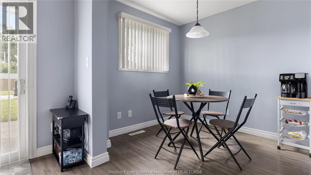 A dining room with a table set for four.