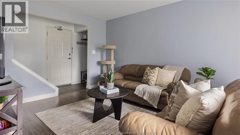 A living room with a brown sofa and a coffee table.