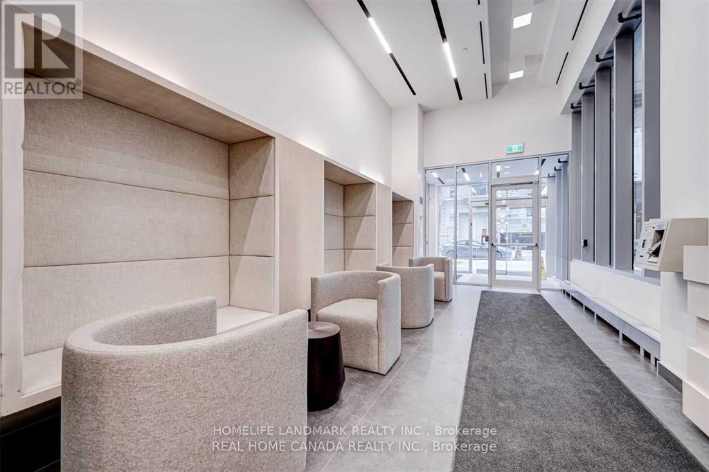 A modern waiting area with white walls and grey carpet.