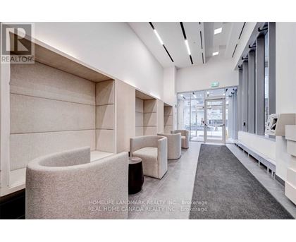 A modern waiting area with white walls and grey carpet.