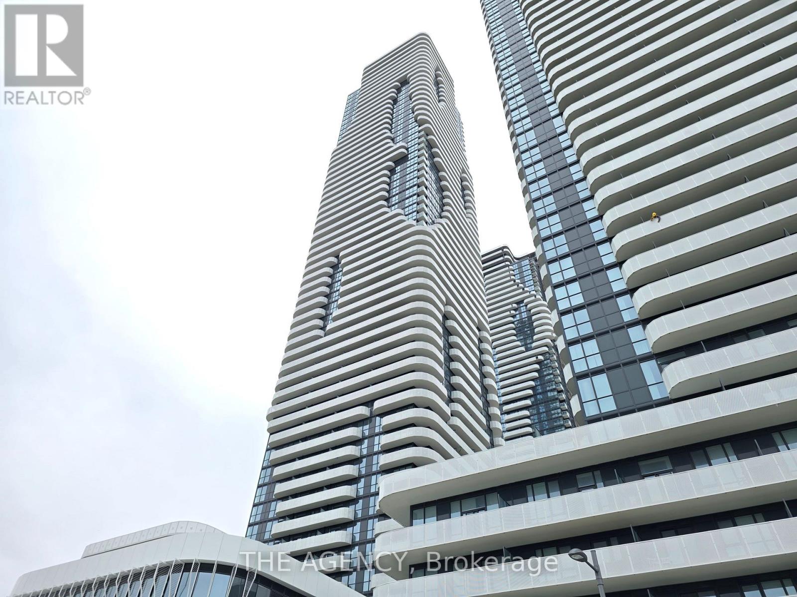 A tall building with a unique design stands out against the sky.