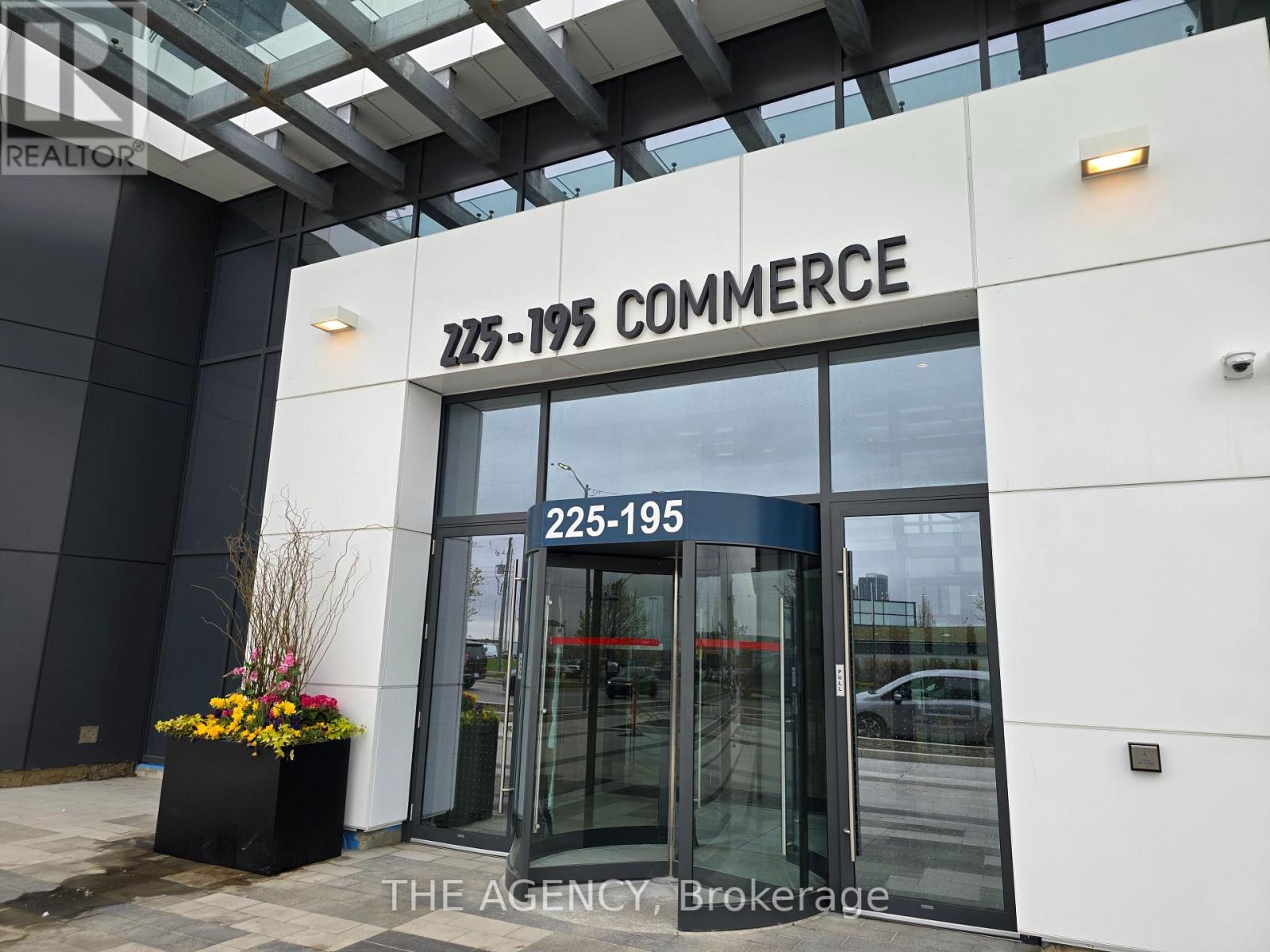 The front of a building with the words 225-195 Commerce on it.