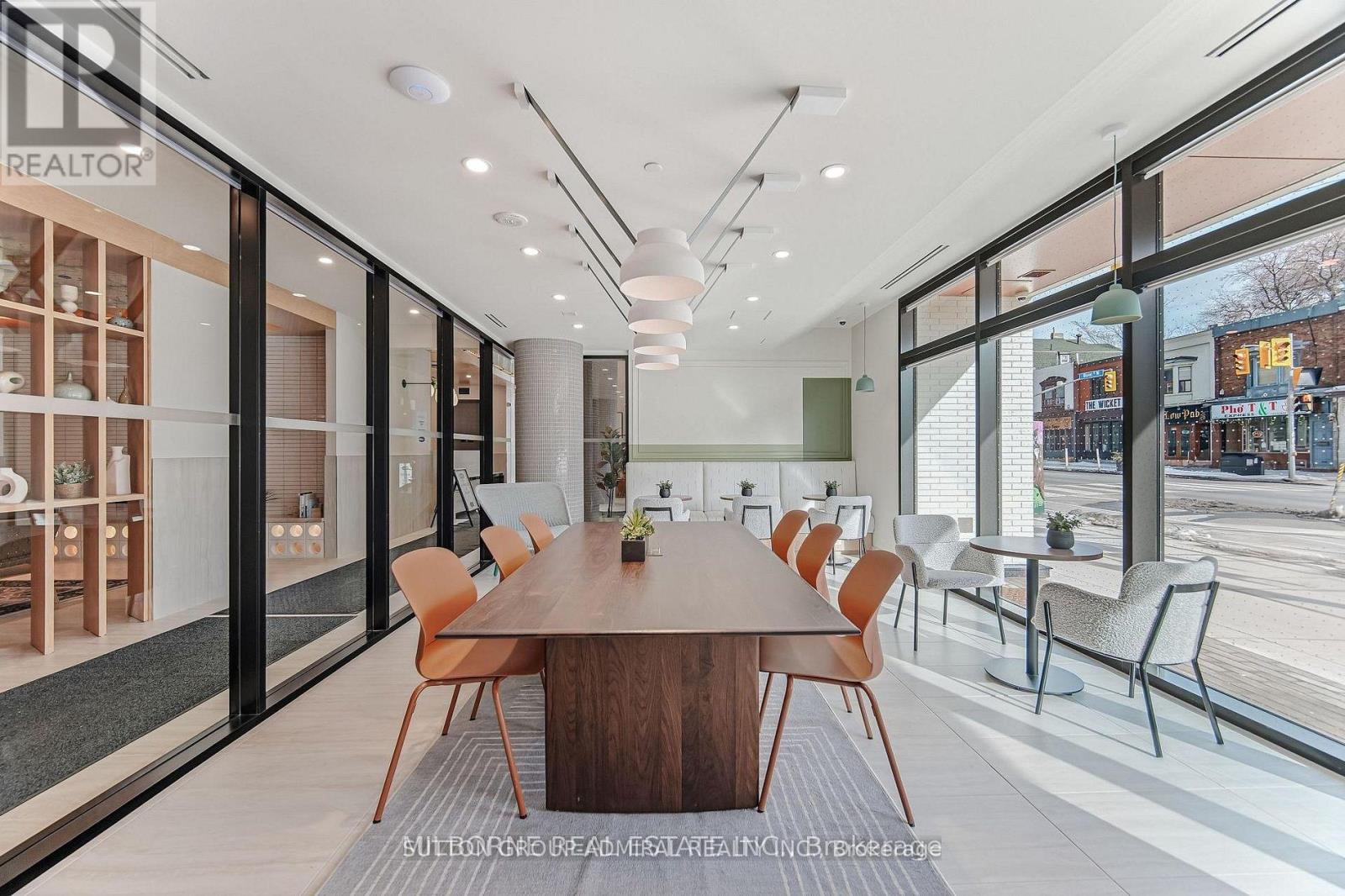 A modern dining room with a long table and chairs.