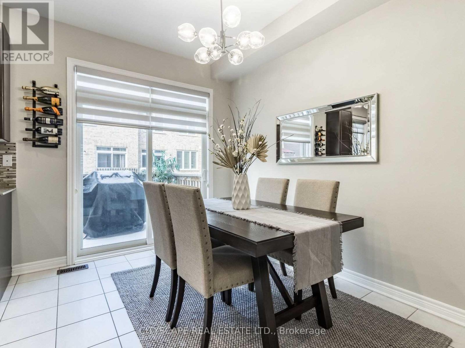 A dining room with a table set for four.