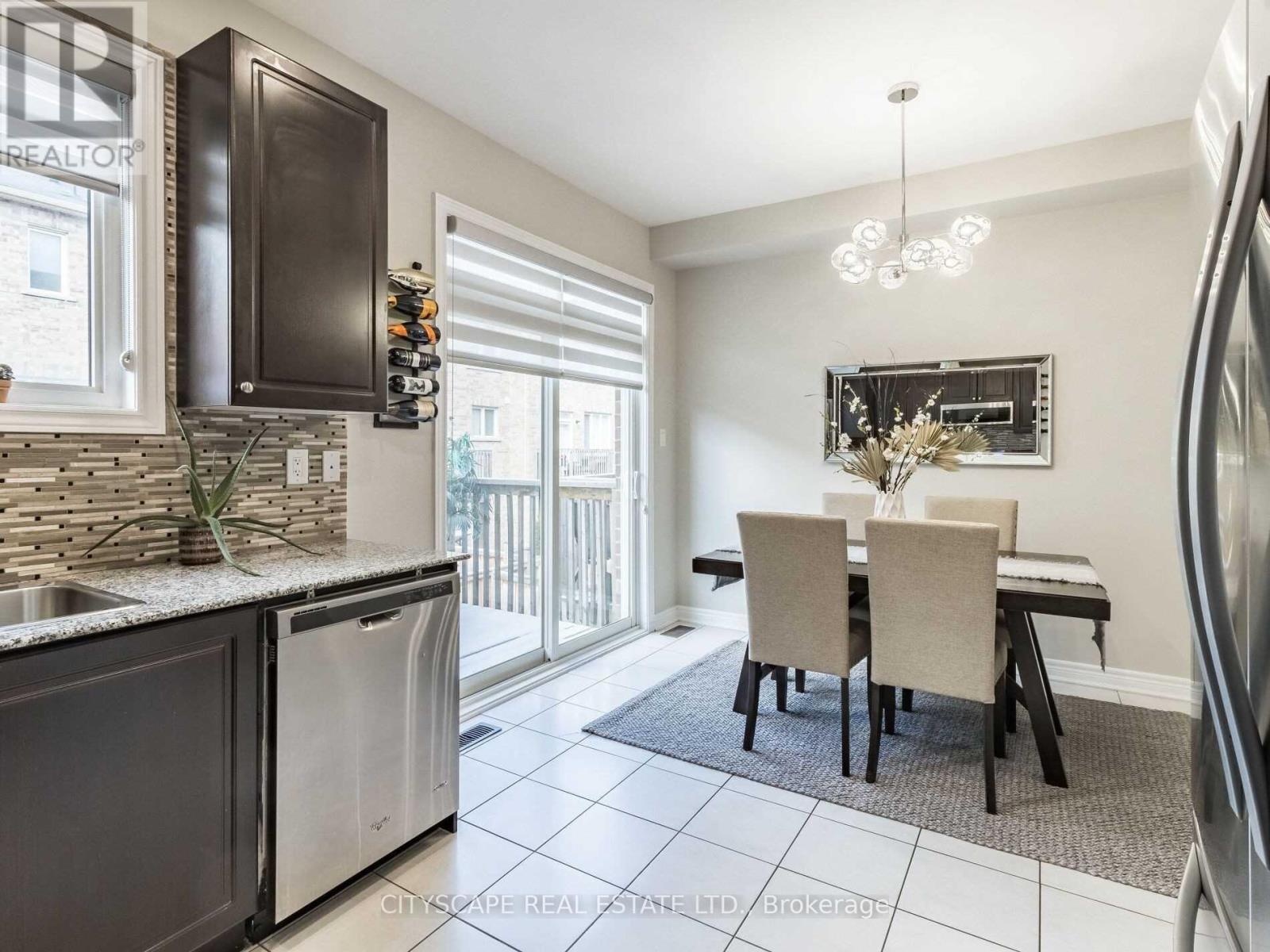 A kitchen with a dining table and chairs.