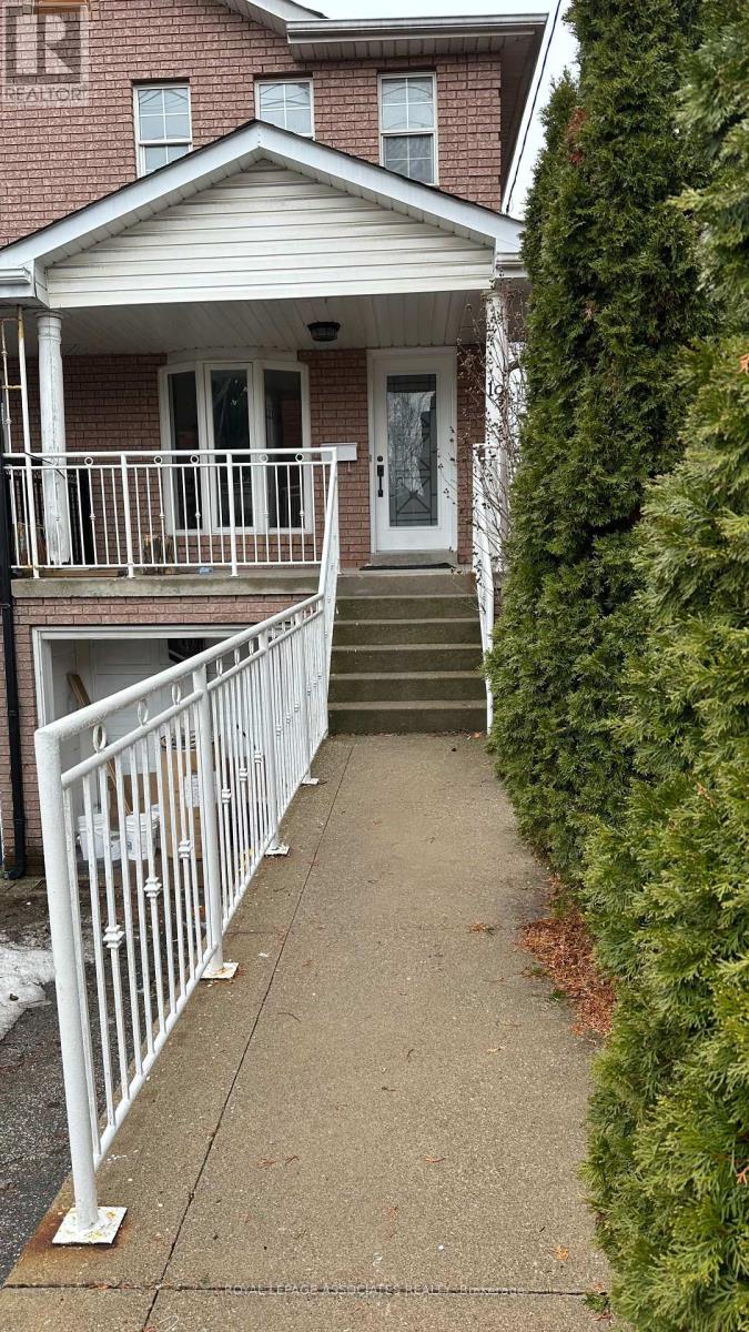 A house with a white fence and a grey front porch.