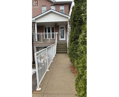 A house with a white fence and a grey front porch.