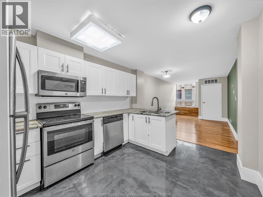 A kitchen with white cabinets and stainless steel appliances.