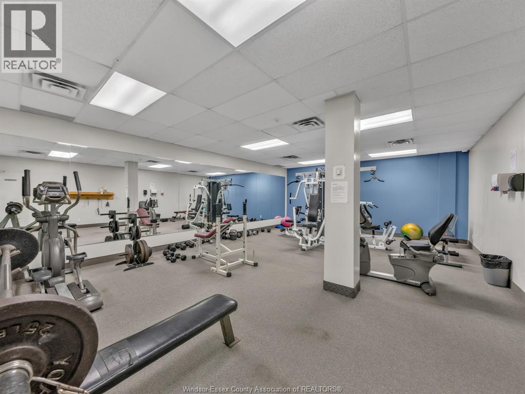 A gym with a variety of equipment including weights and cardio machines.