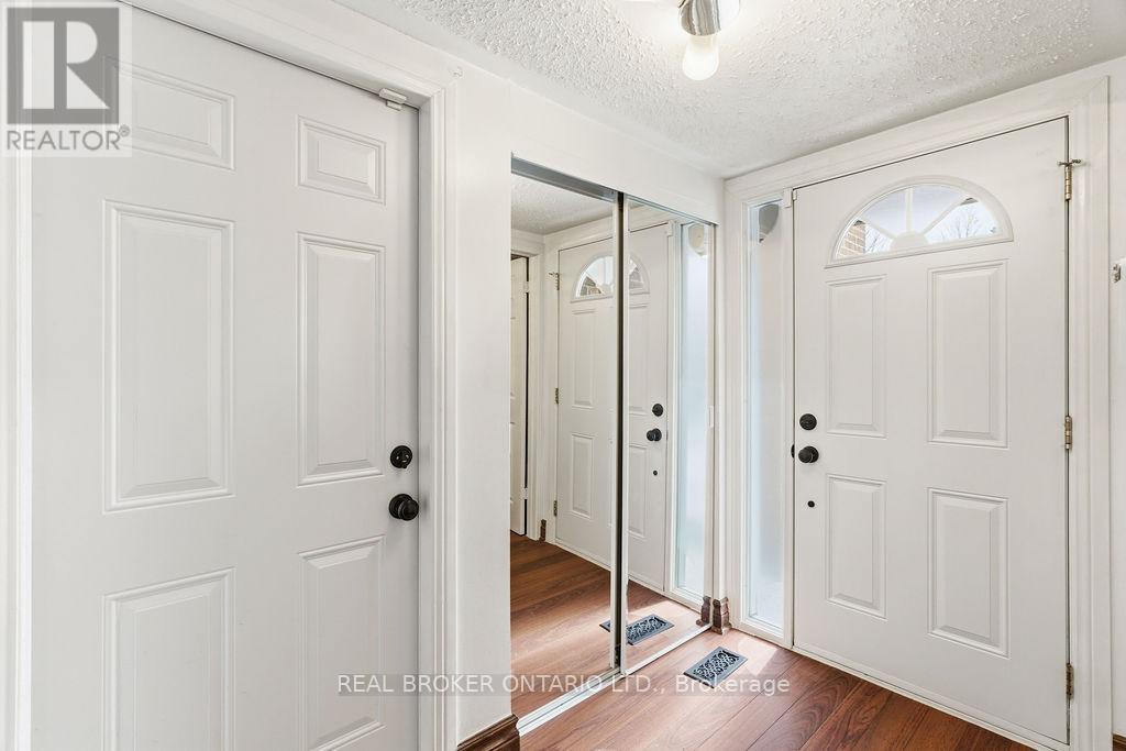 A hallway with white doors and a mirror on the wall.