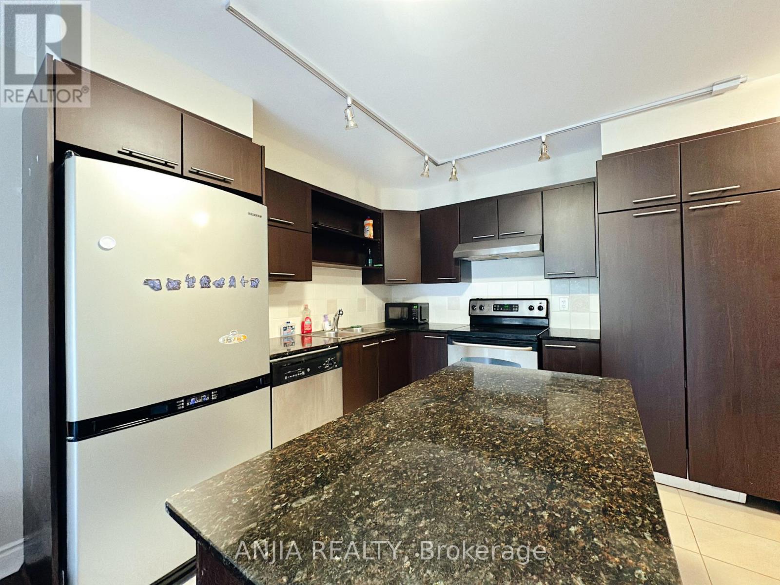 A kitchen with granite countertops and stainless steel appliances.