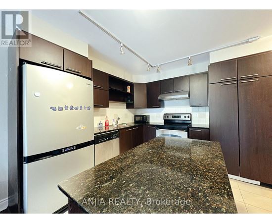 A kitchen with granite countertops and stainless steel appliances.