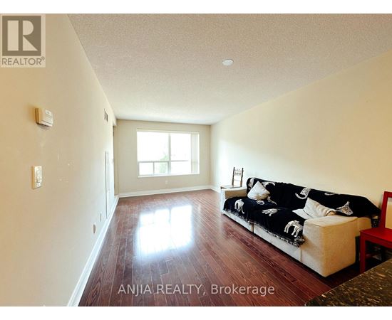A living room with a couch and a window.