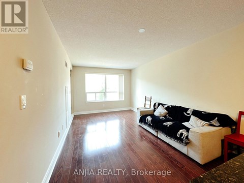 A living room with a couch and a window.