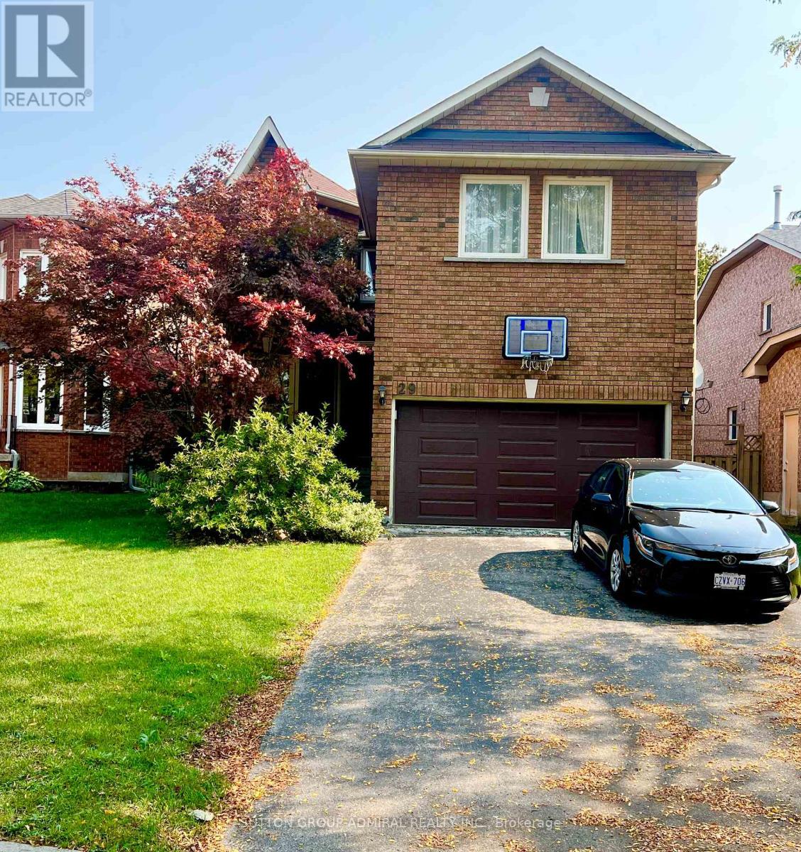 A house with a garage and a car parked in front.