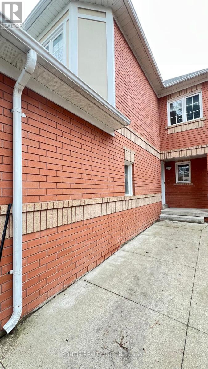 A red brick building with a white gutter.