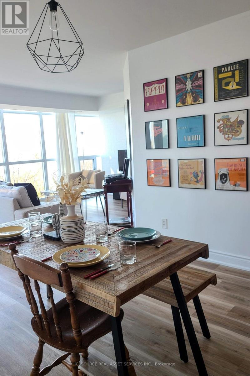 A dining room with a wooden table set for two.