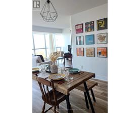 A dining room with a wooden table set for two.