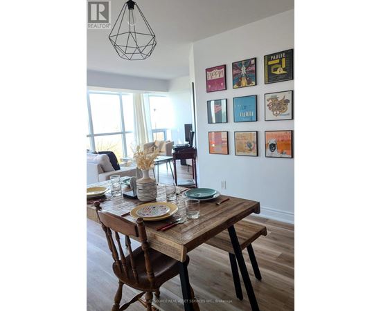 A dining room with a wooden table set for two.
