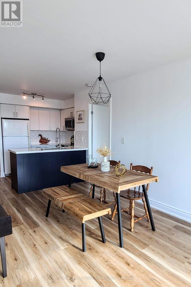 A modern kitchen with a wooden table and chairs.