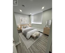 A bedroom with a bed, nightstand, and a mirror.