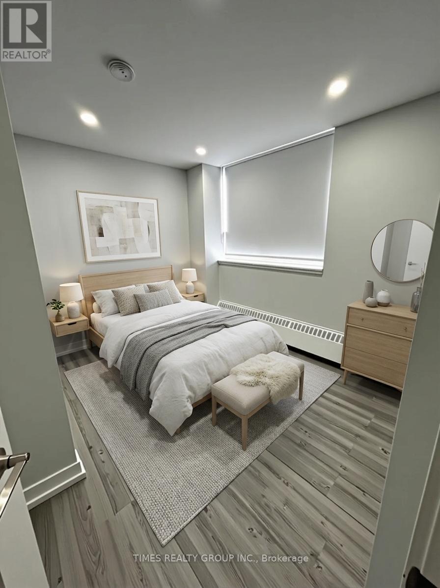 A bedroom with a bed, nightstand, and a mirror.