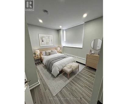 A bedroom with a bed, nightstand, and a mirror.