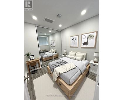 A bedroom with a large bed, a mirror, and two nightstands.
