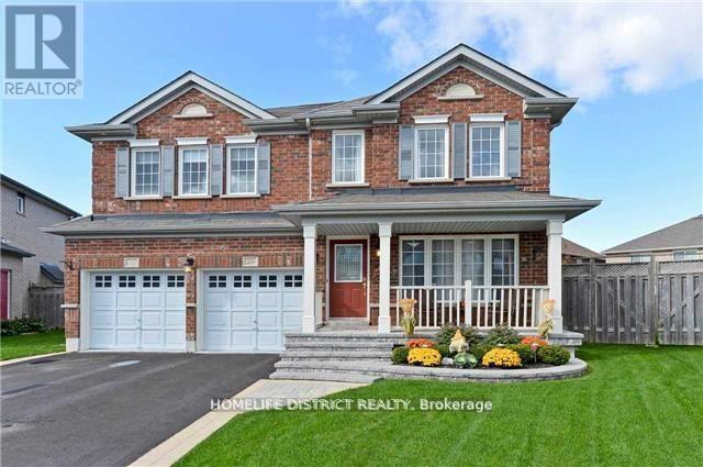 A brick house with a front yard and a garage.