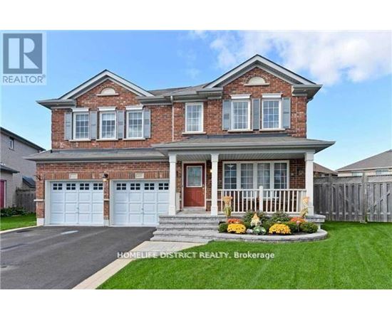 A brick house with a front yard and a garage.