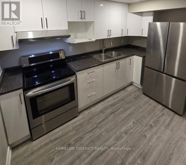 A modern kitchen with stainless steel appliances and white cabinets.