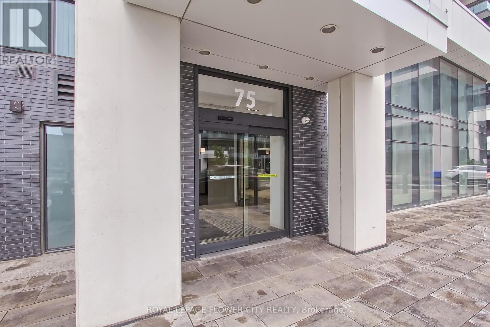 The number 75 is displayed on a glass door.