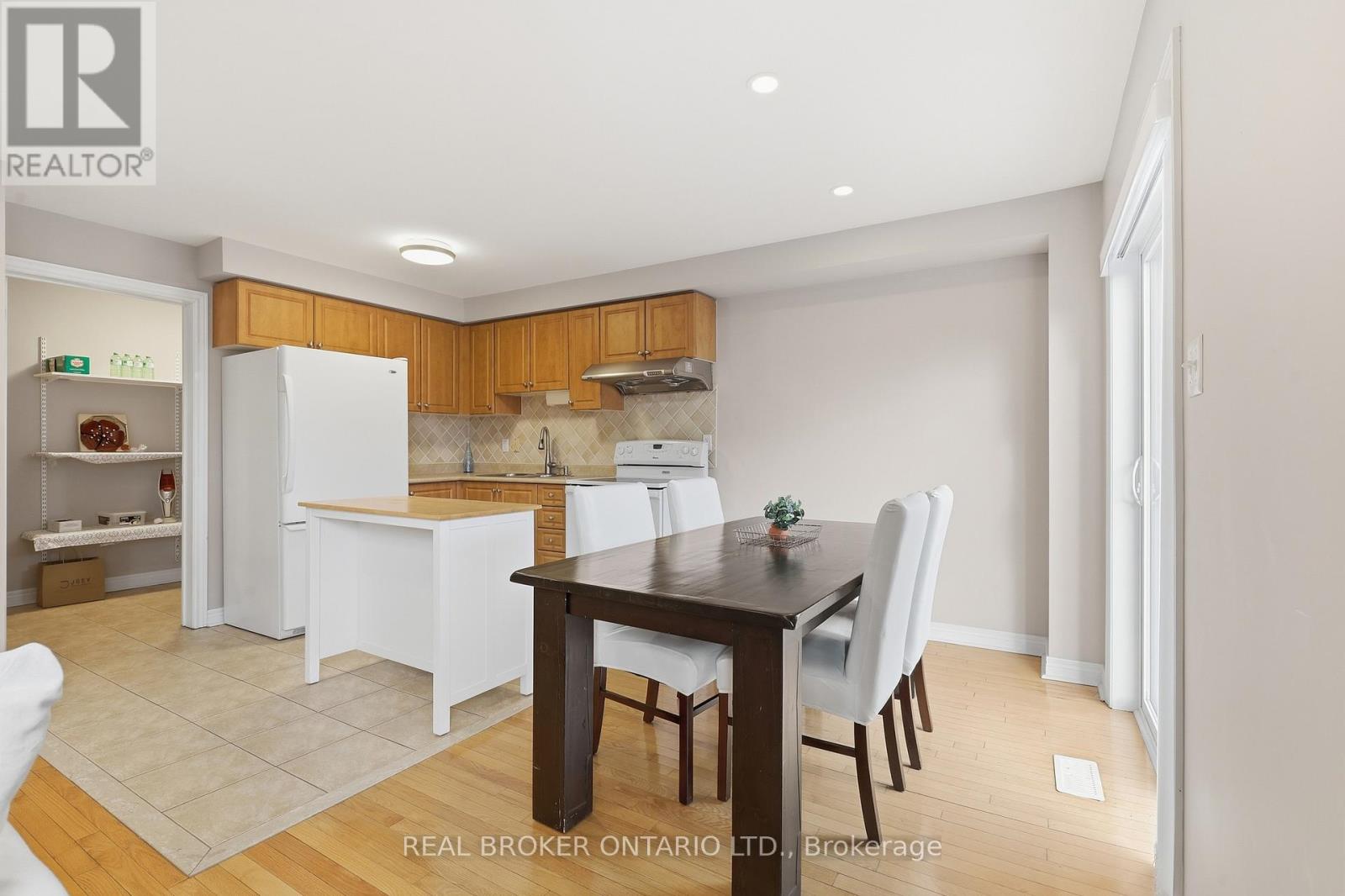 A kitchen with wooden cabinets and white appliances.