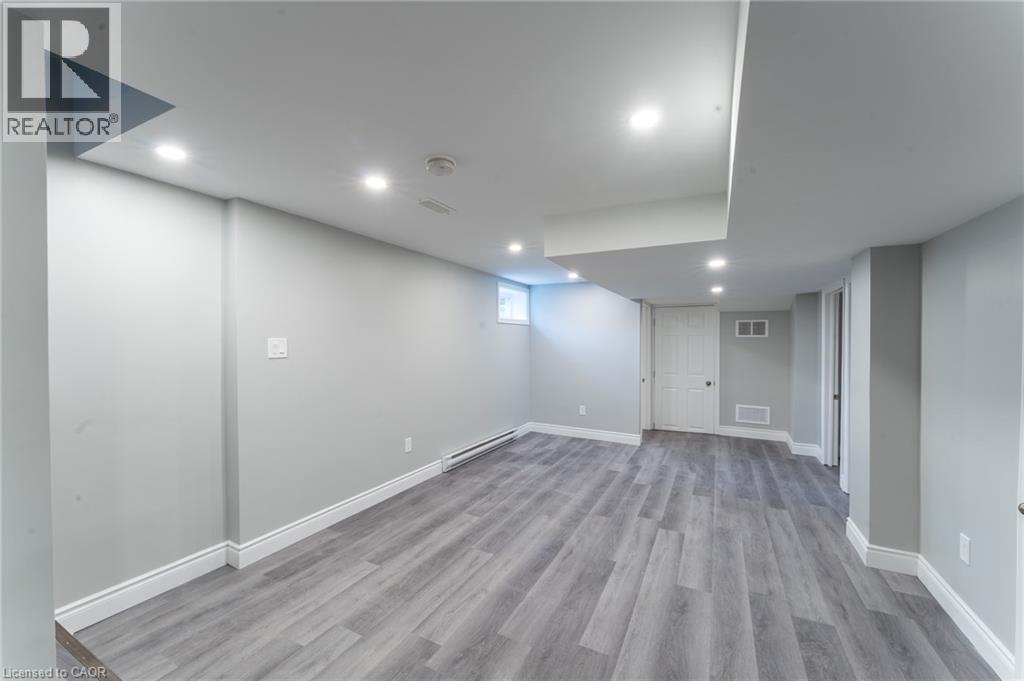 A spacious room with grey flooring and white walls.