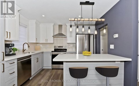 A modern kitchen with white cabinets and a central island.