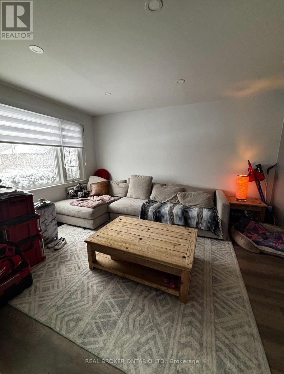 A living room with a couch, a coffee table, and a rug.