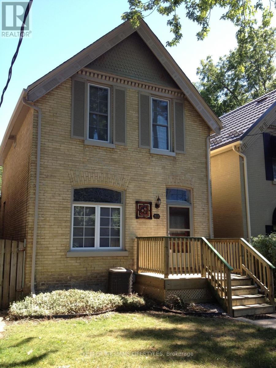 A house with a brown brick exterior and a wooden porch.