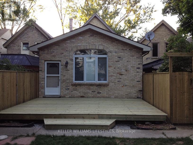 A brick house with a white door and a window.
